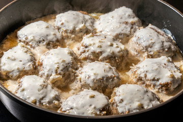 Ground beef meatballs with spices in creamy garlic sauce.