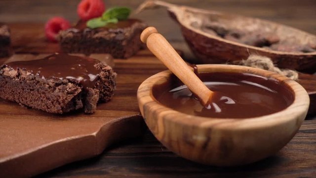 chocolate brownie cake dessert with raspberries and spices on a wooden background.