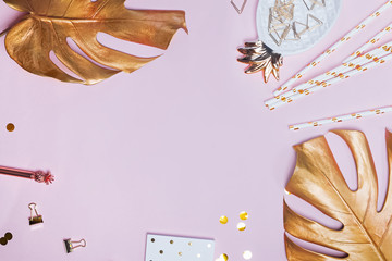 Creative flat lay composition with golden color small decor and gold monstera leaves © Diana Vyshniakova