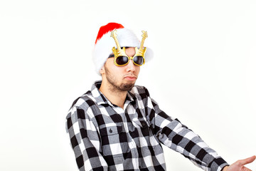 Portrait of a funny young man in Santa Claus hat and beard on white background. Christmas.