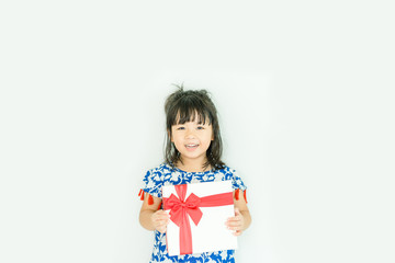 Little asian girl smile and holding red gift box on white background.child holding gift box.