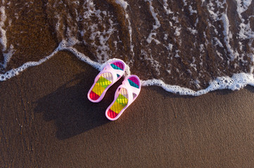 pink beach slippers by the sea
