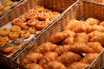 Close up croissants with black sesame and bakery in square bamboo basket