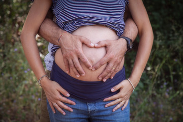 Pregnant woman heart hands