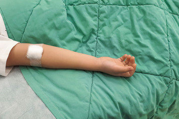 Child's hand in a hospital bed. iv drip in hand Child's in a hospital bed