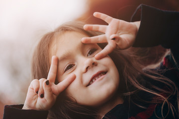 Close up Portrait of cute little girl in autumn forest.