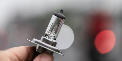 Car headlight bulb luminance with bokeh on the road