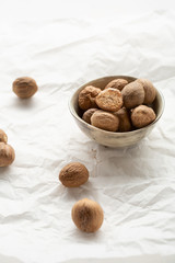Fresh and aromatic nutmeg close-up in bowl