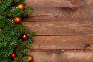 Christmas decor frame and Christmas balls and spruce paws on wooden background