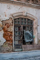 Fototapeta na wymiar shabby windows and doors on the old facade