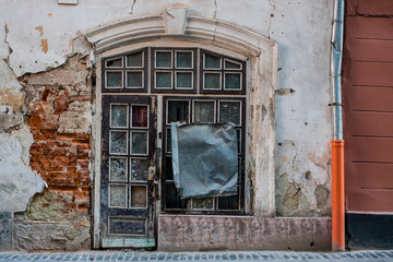 shabby windows and doors on the old facade