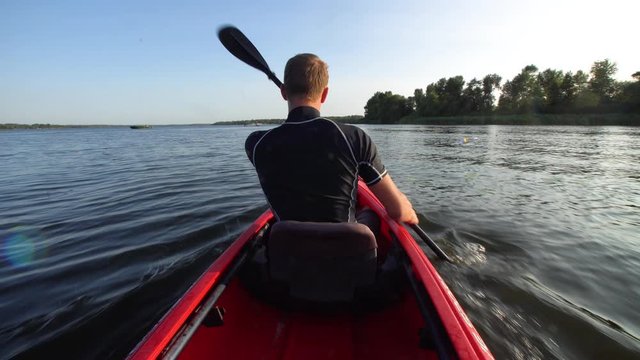 Man in a kayak floating on a river