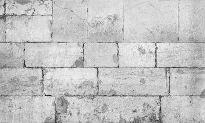 Close-up of an old and weathered wall or flooring made of cement blocks. High resolution full frame textured background in black and white.