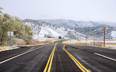 The road going to the mountains against the background of a winter landscape.
