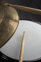 Musical instruments close up. Beautiful snare drum/ hi-hat cymbals with drummer holding drumsticks 