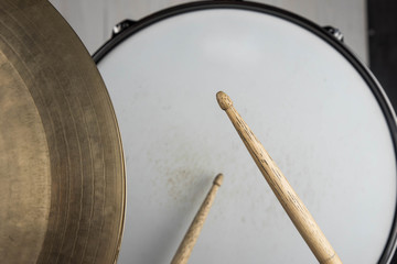 Musical instruments close up. Beautiful snare drum/ hi-hat cymbals with drummer holding drumsticks 