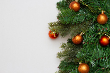 spruce paws with golden christmas balls on whiteon white background