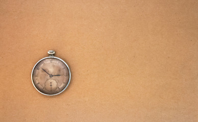 Vintage clock on craft paper. Antique soviet pocket watch