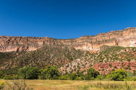 Low angle landscape of multi-colored hillside in Jemez Springs, New Mexico