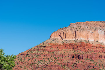 Fototapeta premium Low angle landscape of orange and green stone hill in Jemez National Recreation Area in New Mexico