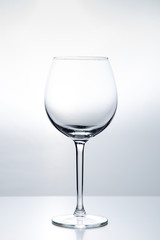Elegant silhouette of an empty wine glass on a white background. Studio shot