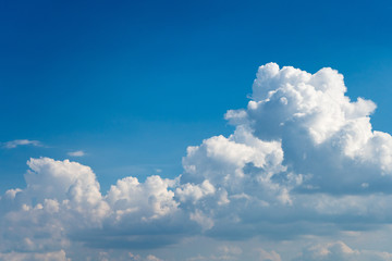 Glowing clouds on a background of blue sky. White fluffy luminous cloud