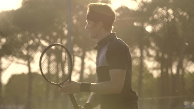 Professional tennis player hitting forehands and backhands while playing on a club hard court.