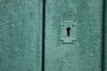 A keyhole in a wooden green door in the historic center of Rio de Janeiro
