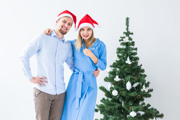 Holidays and celebration concept - Young couple celebrating Christmas at home