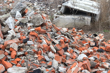 Construction waste with elements of various dismantled and destroyed old structures at municipal landfill