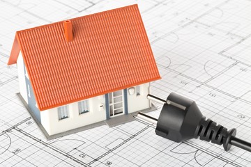 Power cord on building construction blueprint plan with model house - energy saving or power...