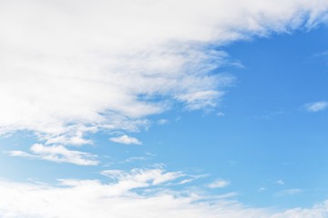 Naklejka na ściany i meble Beautiful white soft fluffy clouds on a blue sky background
