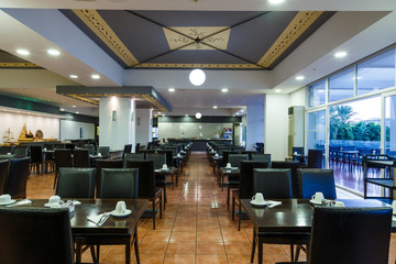 interior of the restaurant of the resort European hotel is all inclusive, large hall with tables waiting for their guests
