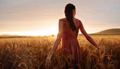 Carefree woman strolling in the wheat field © Jacob Lund