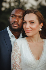 happy and beautiful mixed ethnicity couple with beautiful afro American man and cheerful europian woman loking in different directions