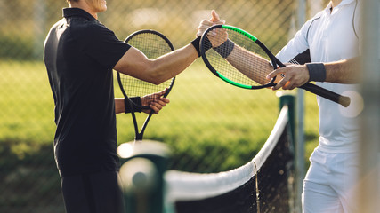 Tennis players shaking hands after the match - Powered by Adobe
