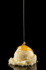 Ice Cream Scoop with Sauce, Vanilla Ice Cream with Pouring Honey Sauce on black background