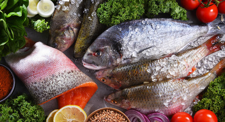 Different sorts of fish on kitchen table