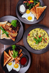 Breakfast foods includes pancakes, eggs and bacon, biscuits, scrambled eggs, cinnamon muffins, fresh blueberries, pancake balls, and cinnamon rolls with icing.