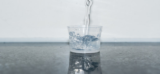 Becher mit Wasser befüllen