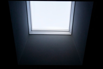 Close up interior view of a real square single window with thick new inner black wall.