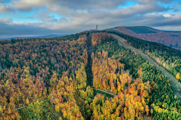 aerial shot of Maple hill with beautifully colored transmitter in autumn colors, Czech , Javorovy...