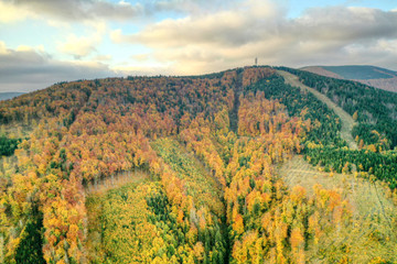 aerial shot of Maple hill with beautifully colored transmitter in autumn colors, Czech , Javorovy...