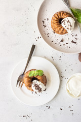 Chocolate dessert decorated with whipped cream, grated chocolate and mint. Traditional Italian dessert panna cotta. Selective focus.