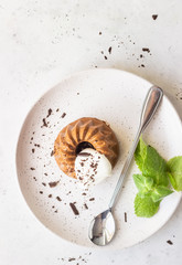 Chocolate dessert decorated with whipped cream, grated chocolate and mint. Traditional Italian dessert panna cotta. Selective focus.