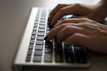 Work on the computer in the office. Female hands on the keyboard.