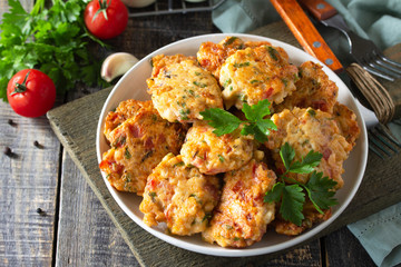 Chicken meatballs with minced meat with tomatoes in a bowl on a wooden rustic table with copy space.