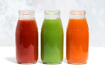 colorful vegetable juices in bottles, closeup