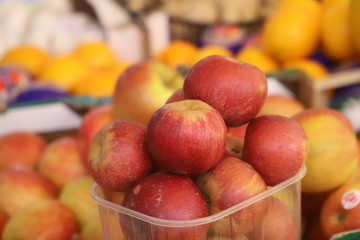 apples on display on a counter in a market