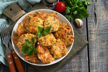 Chicken meatballs with minced meat with tomatoes in a bowl on a wooden rustic table with copy space.